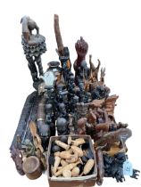 Collection of African carved figures including animals, masks, chess pieces, etc.