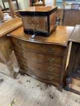 Bevan Funnell Ltd burr walnut serpentine front chest of four long drawers on bracket feet,