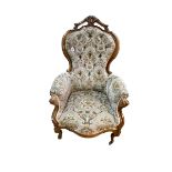 Victorian mahogany framed armchair in sage green and floral decorated buttoned draylon.
