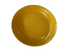 Chinese yellow glaze dish with impressed dragon design, six character mark to base, 19cm diameter.