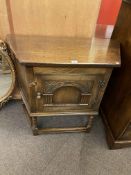 Carved oak canted credence cabinet, 76cm by 84cm by 40cm.