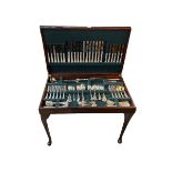 Mahogany table canteen of cutlery with inset leather top, 76cm by 57cm by 47cm.