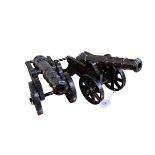Pair of cast metal cannons, 19cm high.