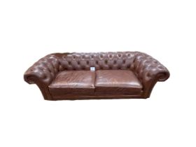 Brown buttoned leather and studded Chesterfield settee, 243cm.