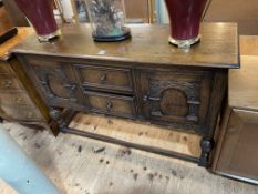 Carved oak sideboard having two central drawers flanked by two carved arched panel doors,