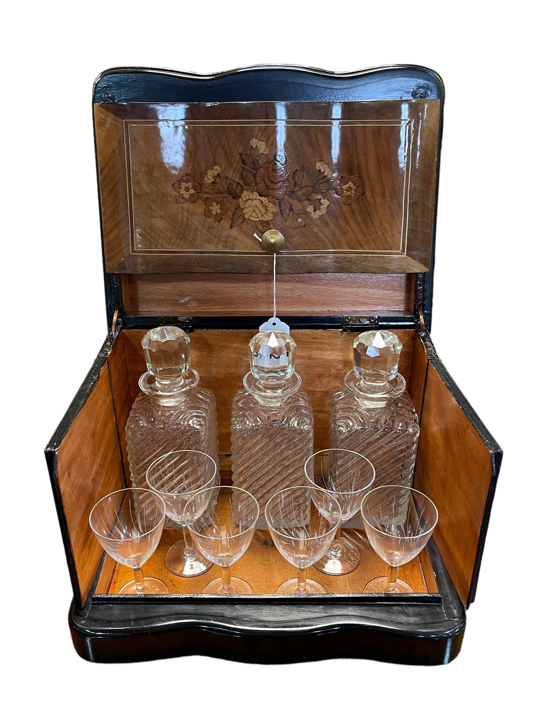Continental floral inlaid and ebonised decanter box with three decanters and six glasses,