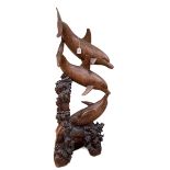 Carved wooden sculpture of three bottle nose dolphins, 149cm in height.