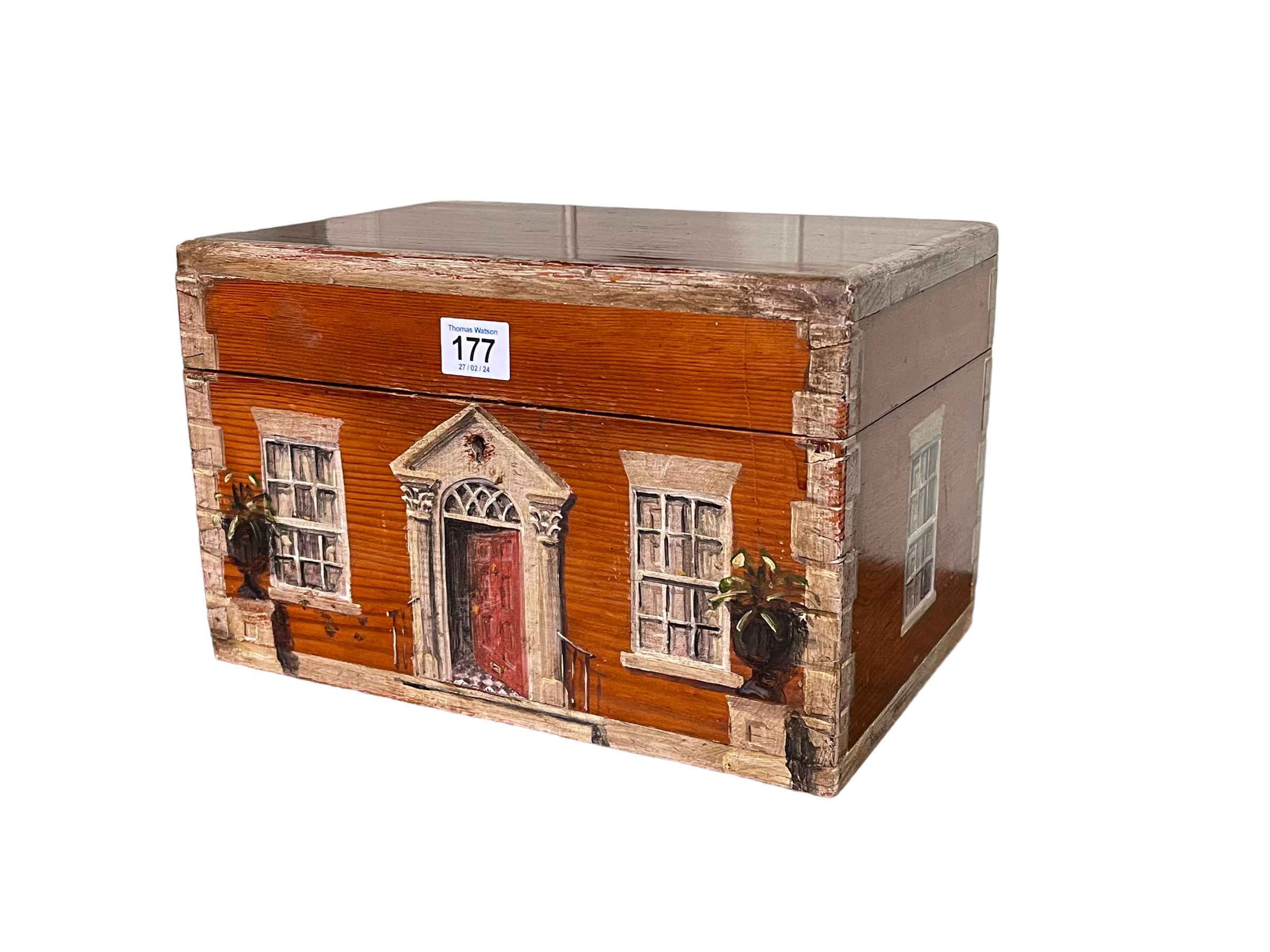 Painted pine box depicting front and two sides of a house, 31cm by 20cm by 20cm.