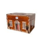 Painted pine box depicting front and two sides of a house, 31cm by 20cm by 20cm.