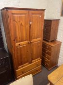 Pine three piece bedroom suite comprising double door wardrobe with two base drawers,