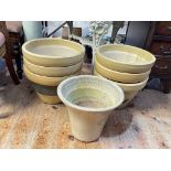Seven cream stoneware plant pots.