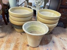 Seven cream stoneware plant pots.