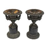 Pair of ornate bronze and marble urns, 31cm.