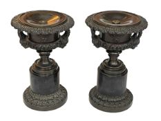 Pair of ornate bronze and marble urns, 31cm.