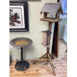 Cast metal bird bath and a wood bird table with feeder.