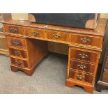 Yew six drawer pedestal desk, 77cm by 122cm by 62cm.