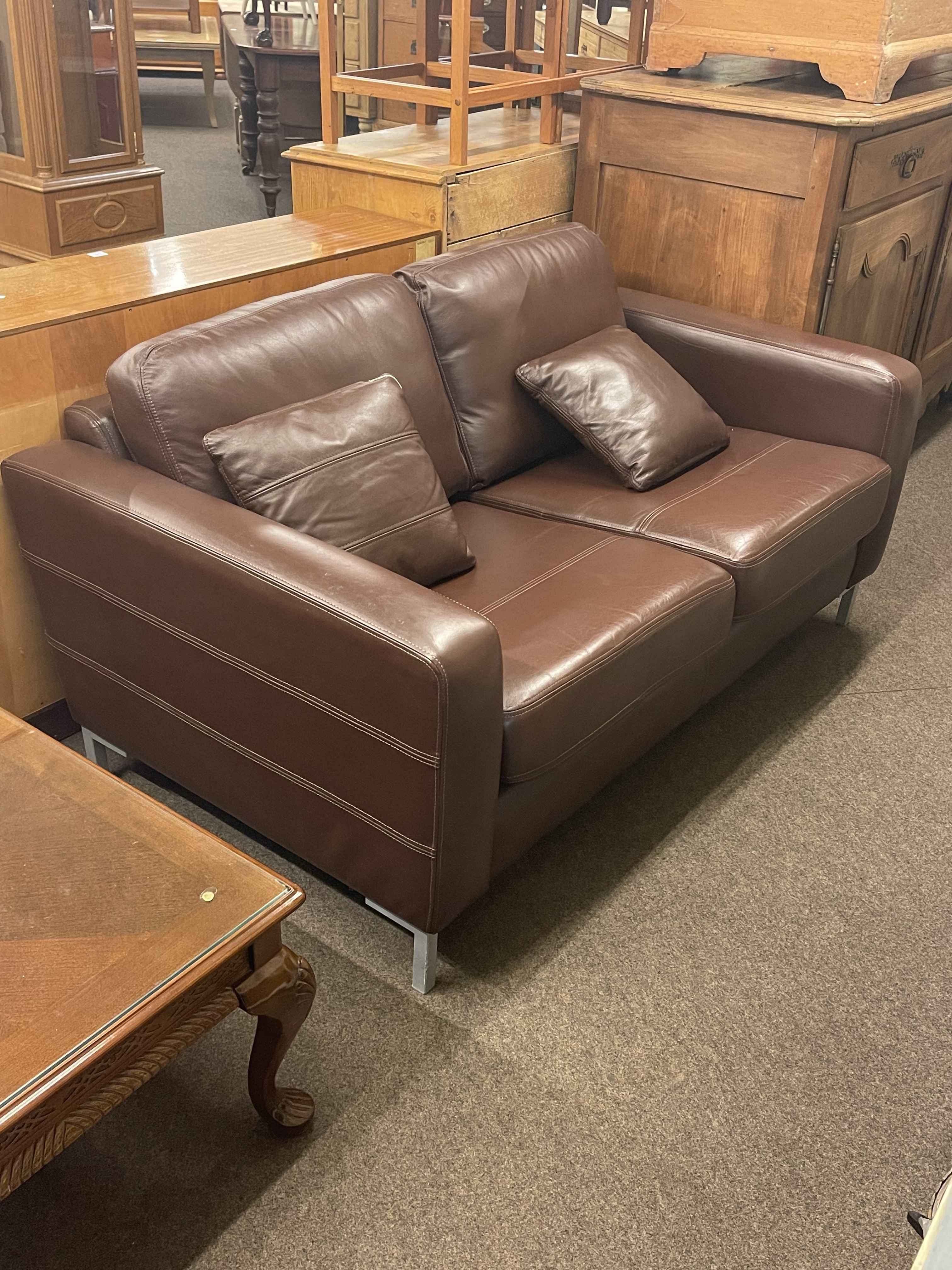 Contemporary chocolate brown leather two seater settee.