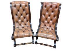 Pair tan buttoned leather and brass studded slipper chairs.