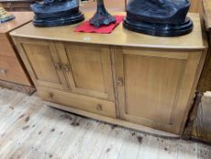 Ercol Windsor sideboard having three doors and a base drawer,