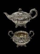 Early Victorian silver teapot and sugar basin, the bodies with foliate embossed panels,