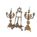 Pair of ornate gilt candelabra and an easel.
