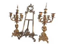 Pair of ornate gilt candelabra and an easel.