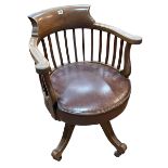 Early 20th Century mahogany swivel office desk chair in brown hide.