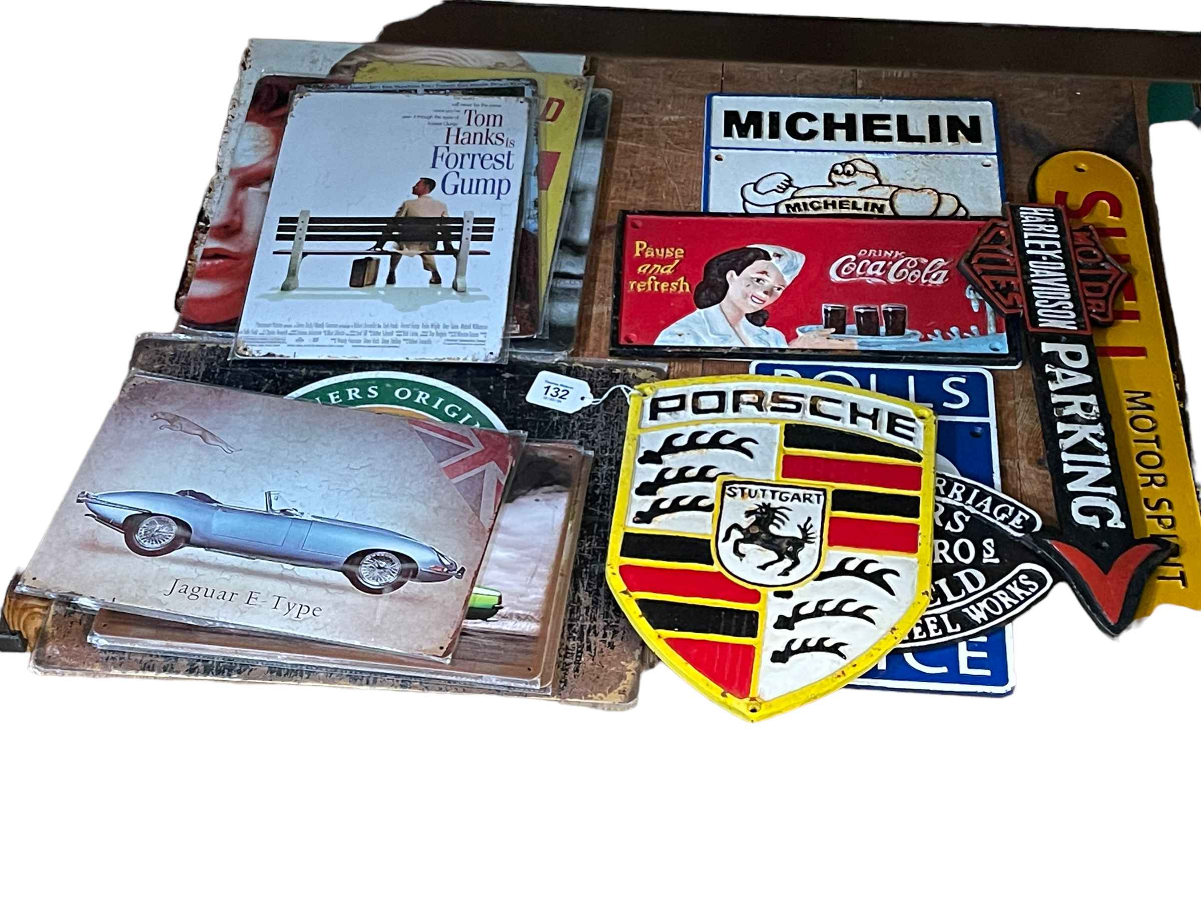 Seven cast metal signs including motoring interest and Coca-Cola, together with assorted tin signs.