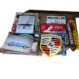 Seven cast metal signs including motoring interest and Coca-Cola, together with assorted tin signs.