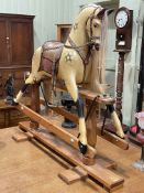 Sponge painted rocking horse on pine safety stand, 110cm by 134cm.