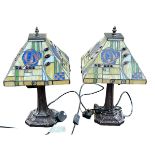 Pair of Tiffany style table lamps with coloured leaded glass shades.