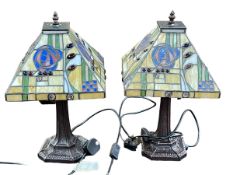 Pair of Tiffany style table lamps with coloured leaded glass shades.