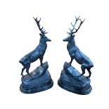 Pair of impressive bronze stags standing on rocky outcrop to marble base, 74cm.