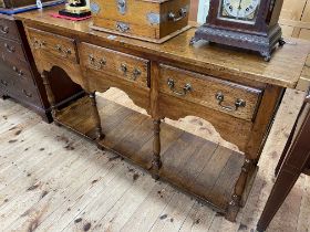 Period style oak three drawer potboard dresser, 77cm by 141cm by 44.5cm.