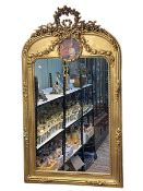 Rectangular gilt framed wall mirror with floral garland crest and circular panel, 126cm by 74cm.