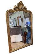 Large gilt framed arched top bevelled wall mirror with shell, swag and floral crest, 230cm by 140cm.