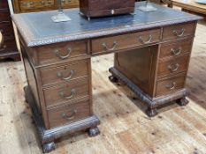 Edwardian carved mahogany nine drawer pedestal desk on ball and claw legs, 77cm by 122cm by 68.5cm.
