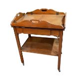 Mahogany butlers tray with folding sides on two tier stand with central drawer,