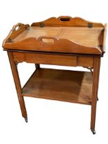 Mahogany butlers tray with folding sides on two tier stand with central drawer,