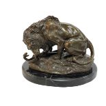 Bronze figure of a Lion Attacking a Snake on marble base, 24cm.