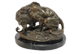 Bronze figure of a Lion Attacking a Snake on marble base, 24cm.