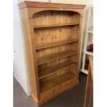 Pine for tier open bookcase with two base drawers, 183cm by 122cm by 35cm.