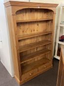 Pine for tier open bookcase with two base drawers, 183cm by 122cm by 35cm.