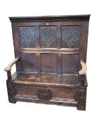Antique carved oak high back box settle, 145cm by 137cm by 55cm.
