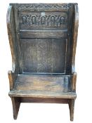 Antique carved oak small wing back settle, 117cm by 66cm by 37cm.