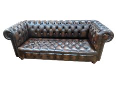 Brown deep buttoned leather and studded three seater Chesterfield settee.