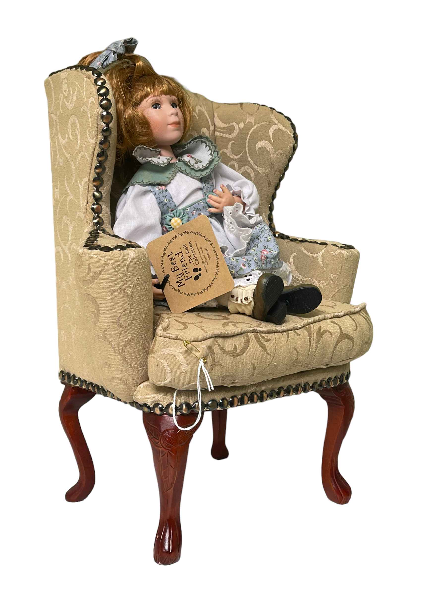 My Best Friend doll seated in a Queen Anne style wing back armchair.
