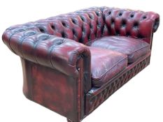 Ox blood deep buttoned leather two seater Chesterfield settee.