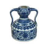 Chinese blue and white twin handled vase with symmetrical floral design with Qianlong mark to base,