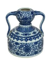 Chinese blue and white twin handled vase with symmetrical floral design with Qianlong mark to base,